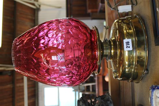 Brass oil lamp with ruby glass shade